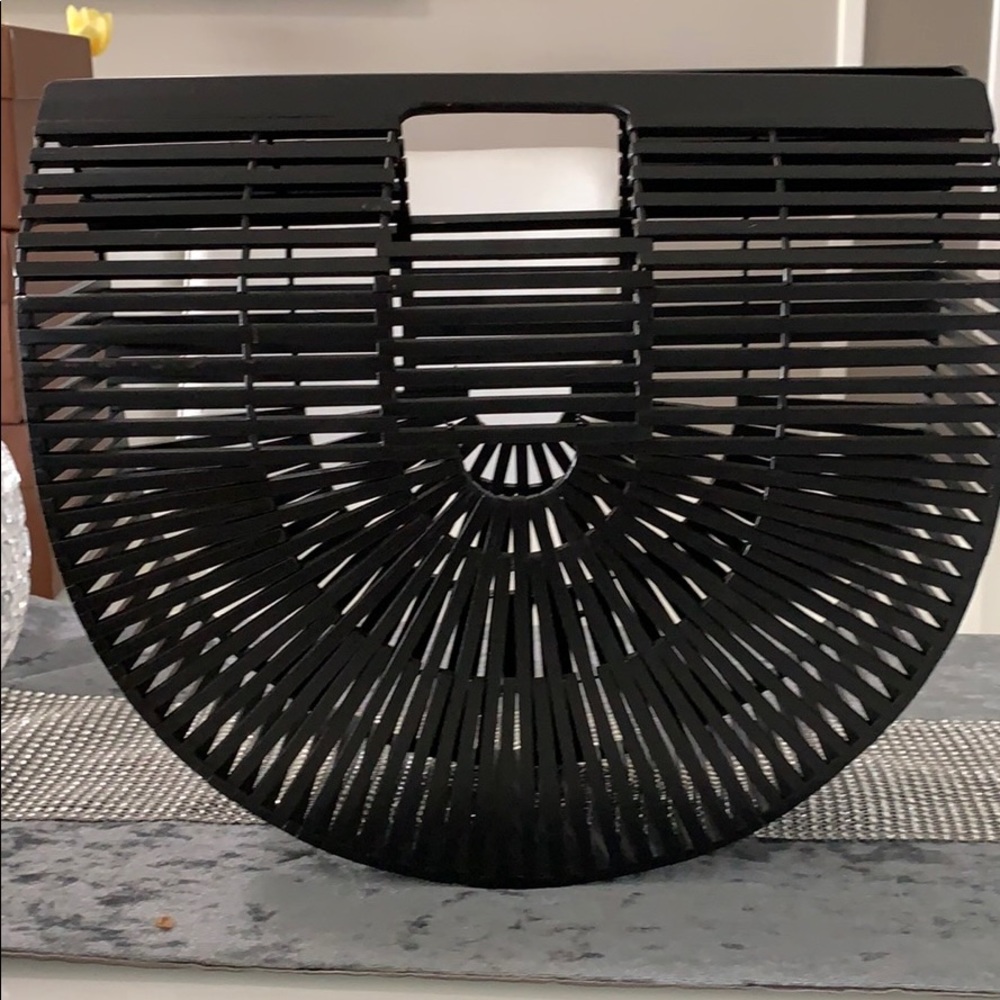 Black Ark clutch, top handles and a cut detail.